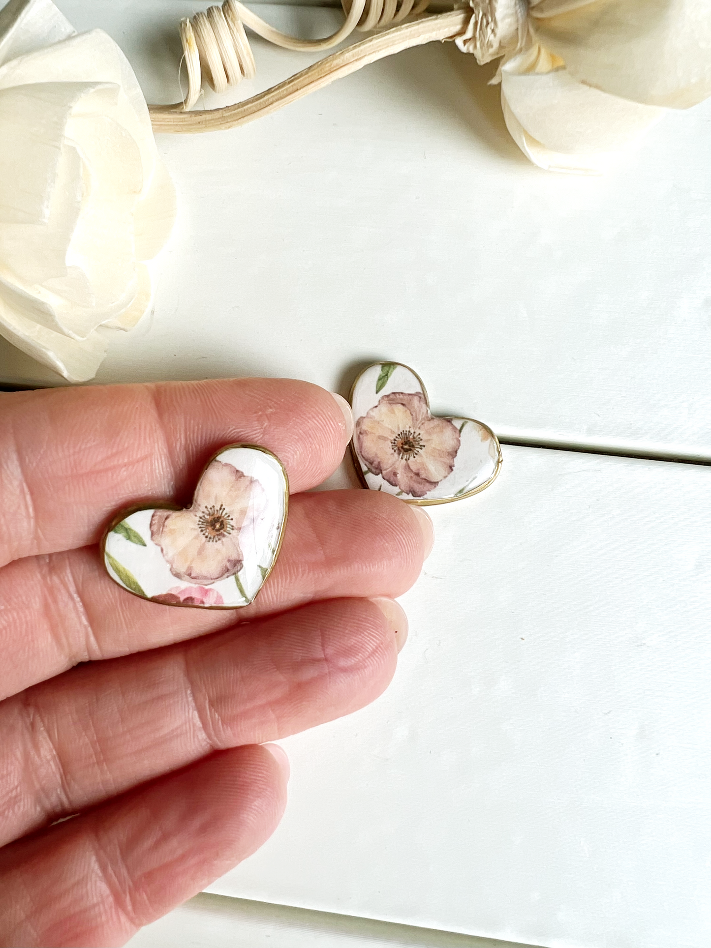Floral heart earrings with gold edge.