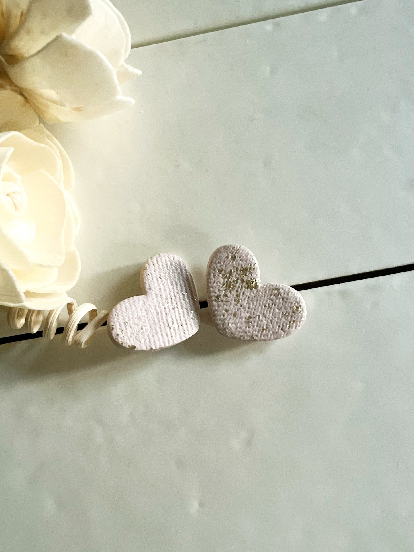 White heart earrings with gold leaf and fabric texture