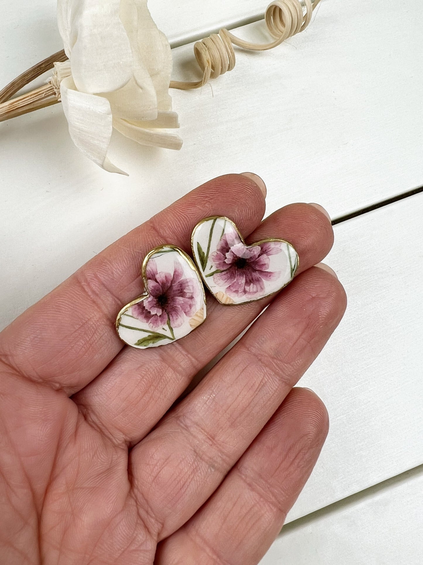 Floral heart earrings with gold edge.