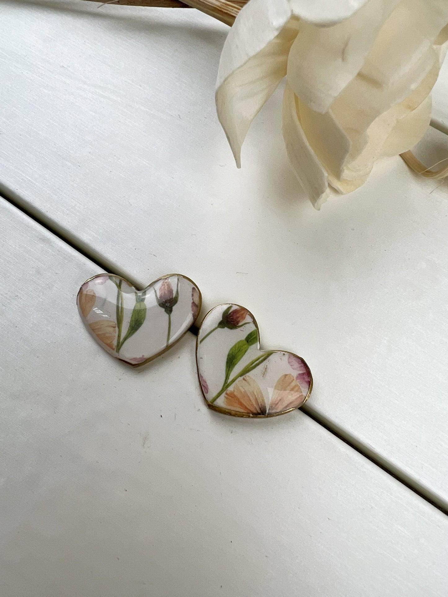 Floral heart earrings with gold edge.