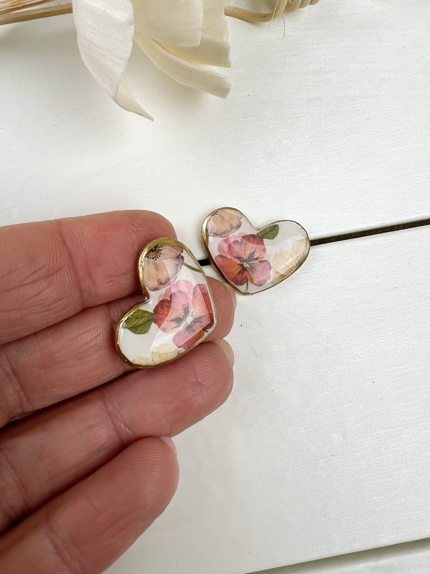 Floral heart earrings with gold edge.
