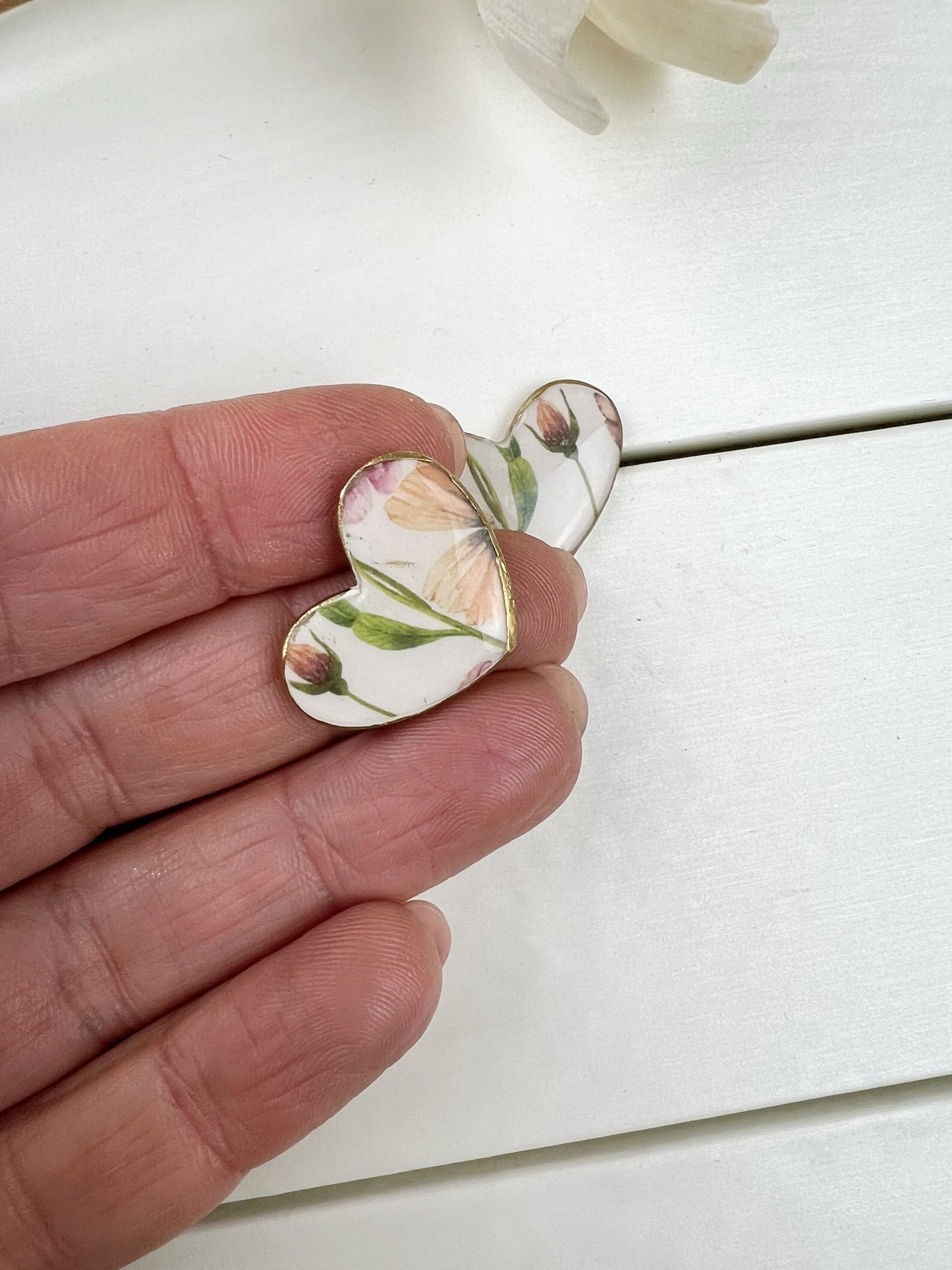 Floral heart earrings with gold edge.