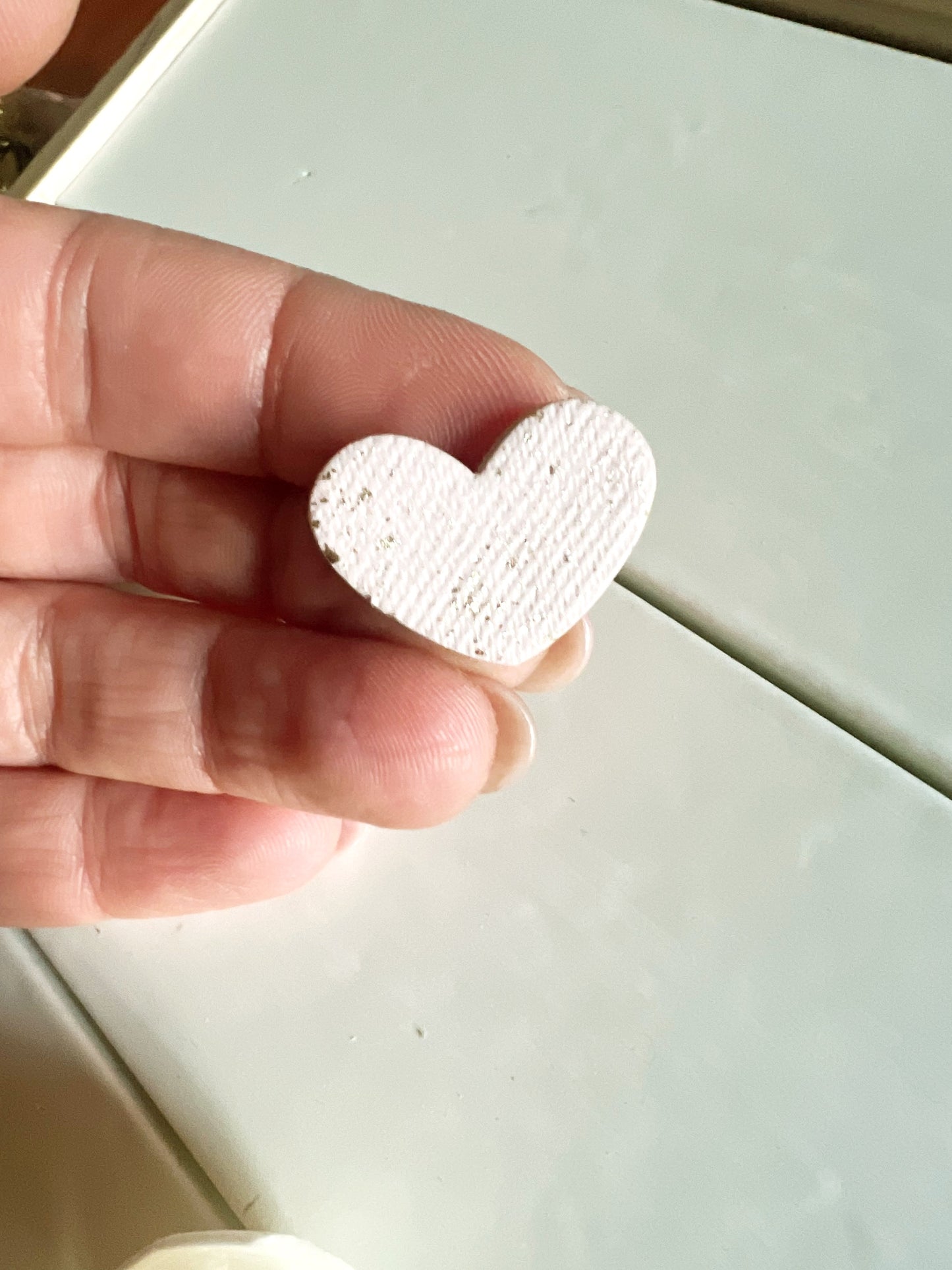 White heart earrings with gold leaf and fabric texture