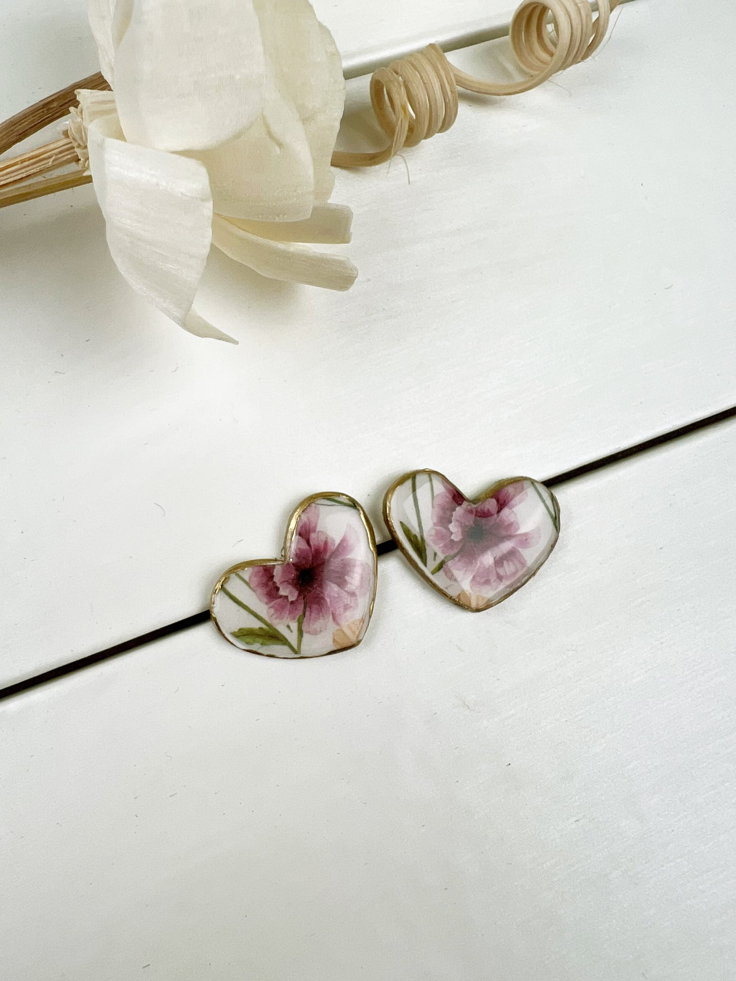 Floral heart earrings with gold edge.